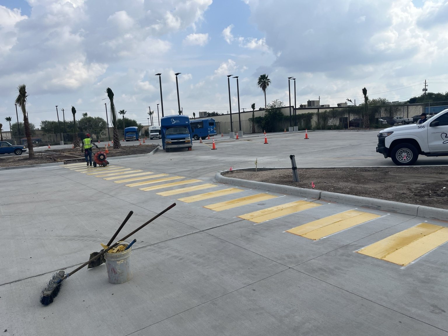 Concrete parking area with yellow pedestrian crossing