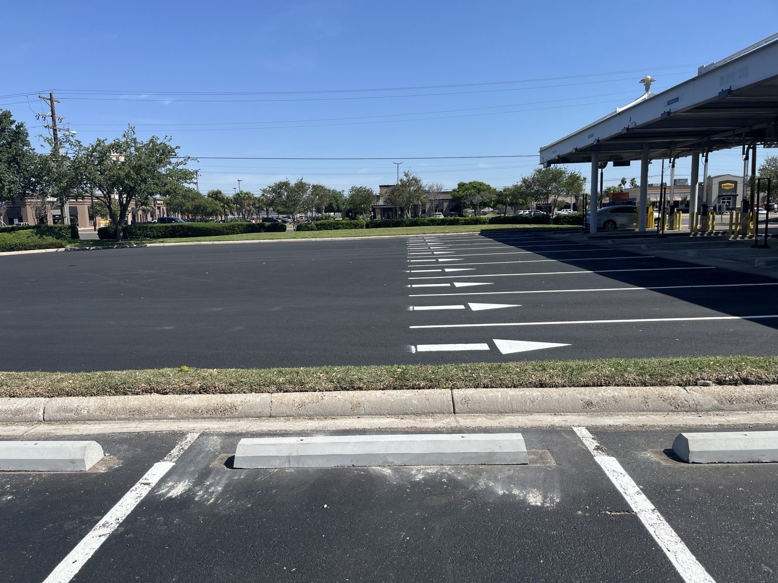 Commercial parking lot with white directional markings